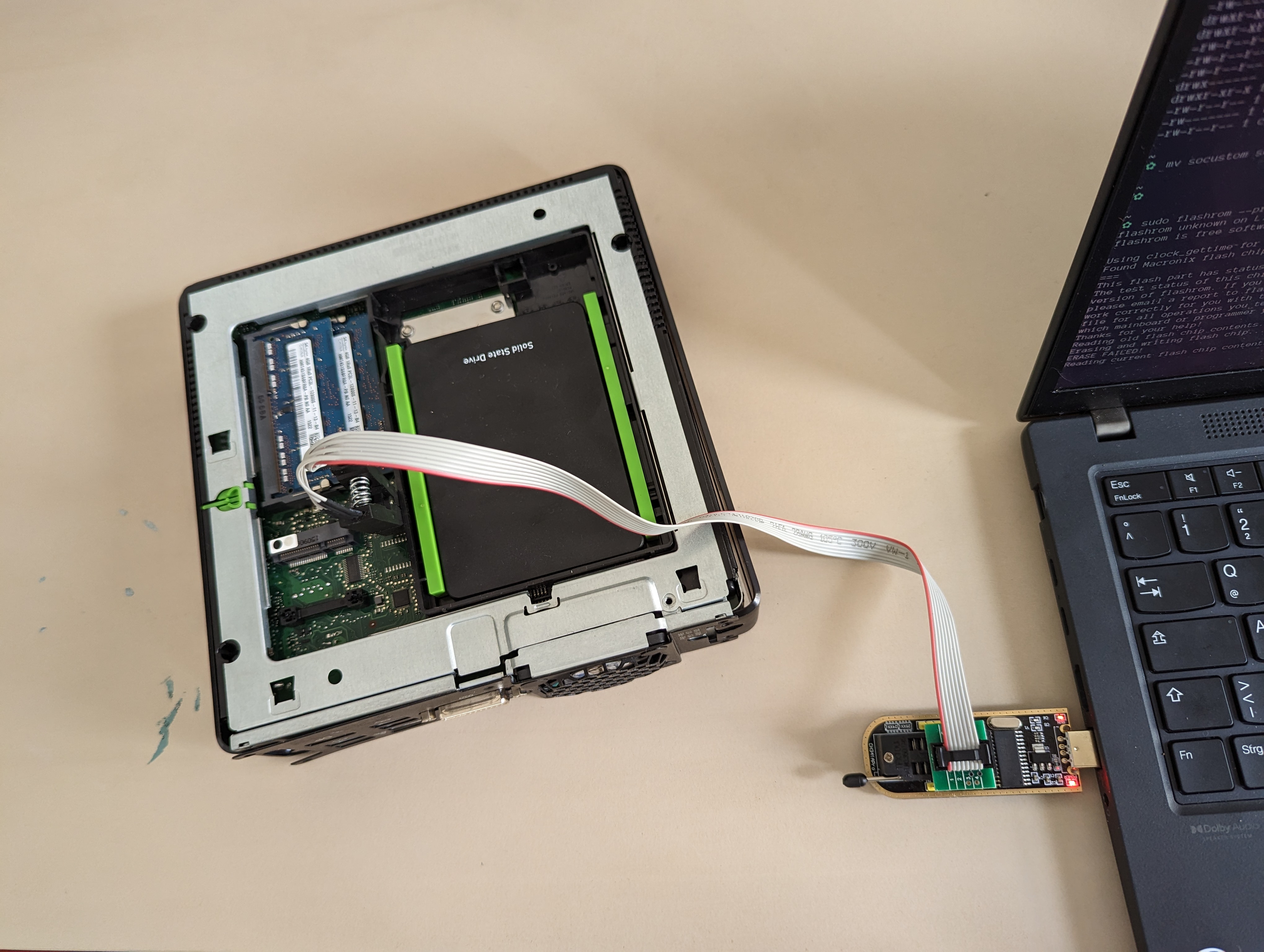 Image of an SPI programmer connected to a laptop